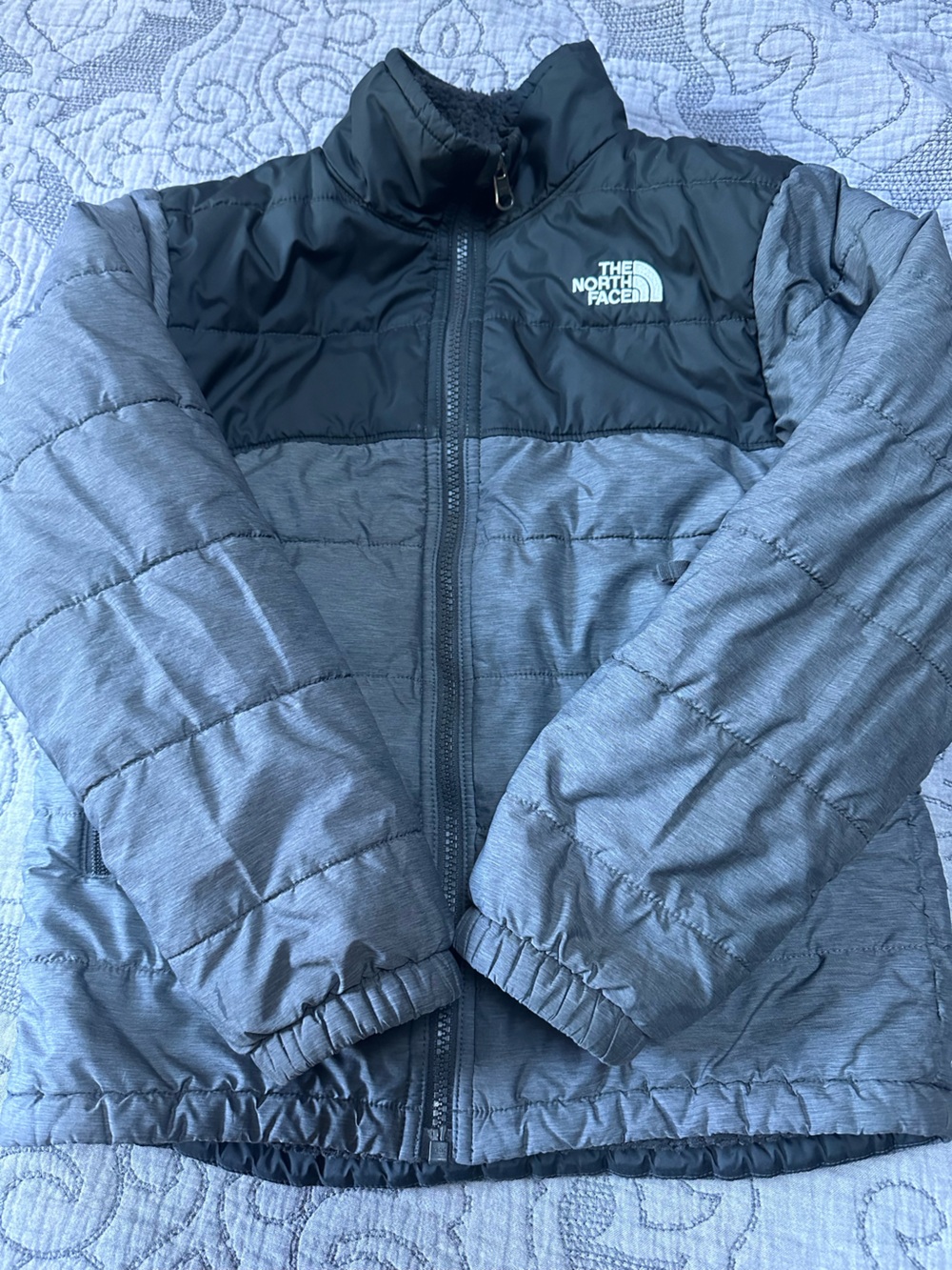 The North Face Boys' Quilted Jacket in Heather grey and black.
